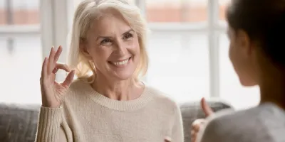 An older woman smiling during a therapy session